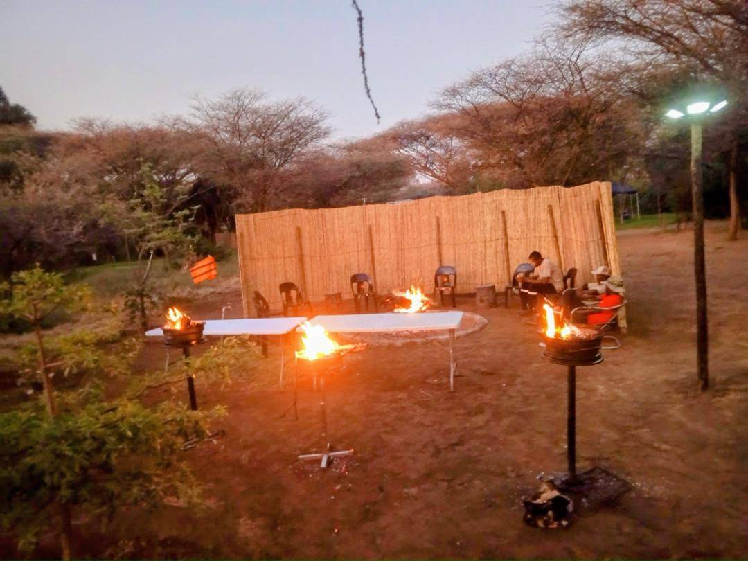 Guests gathered around the fire in the boma at night