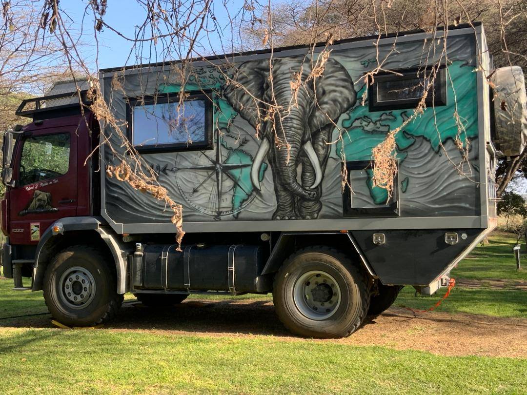 An overland truck parked on the grass