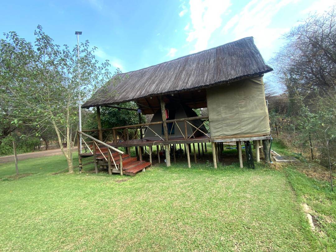 A raised thatched deck on the grounds